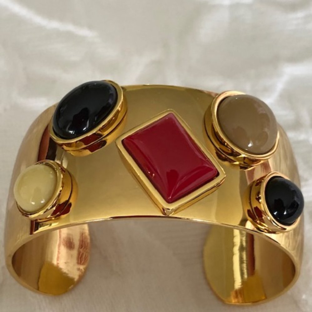 Gold cuff bracelet with red and black accents